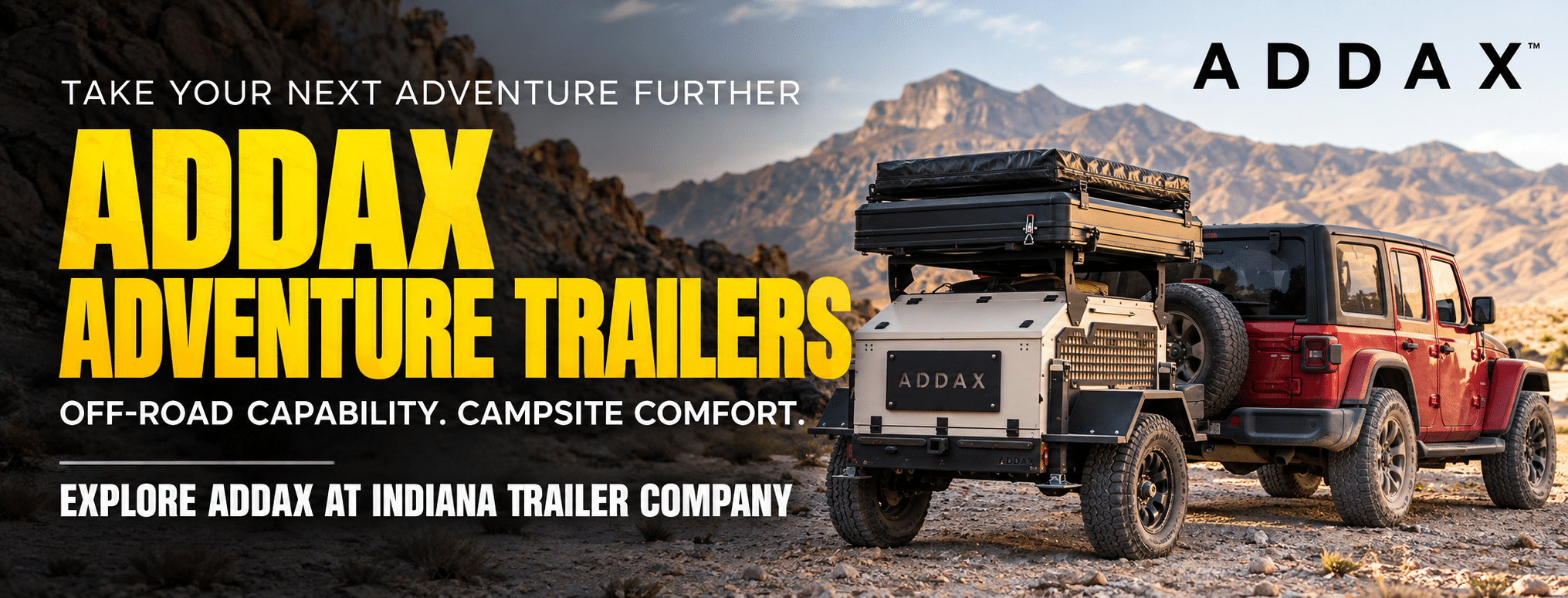 ADDAX adventure trailer with rooftop tent hitched to a Jeep in the mountains, available at Indiana Trailer Company.